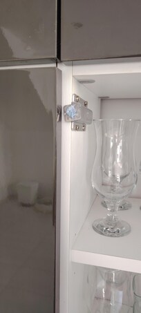Lounge cupboard catch held on with Blu tac