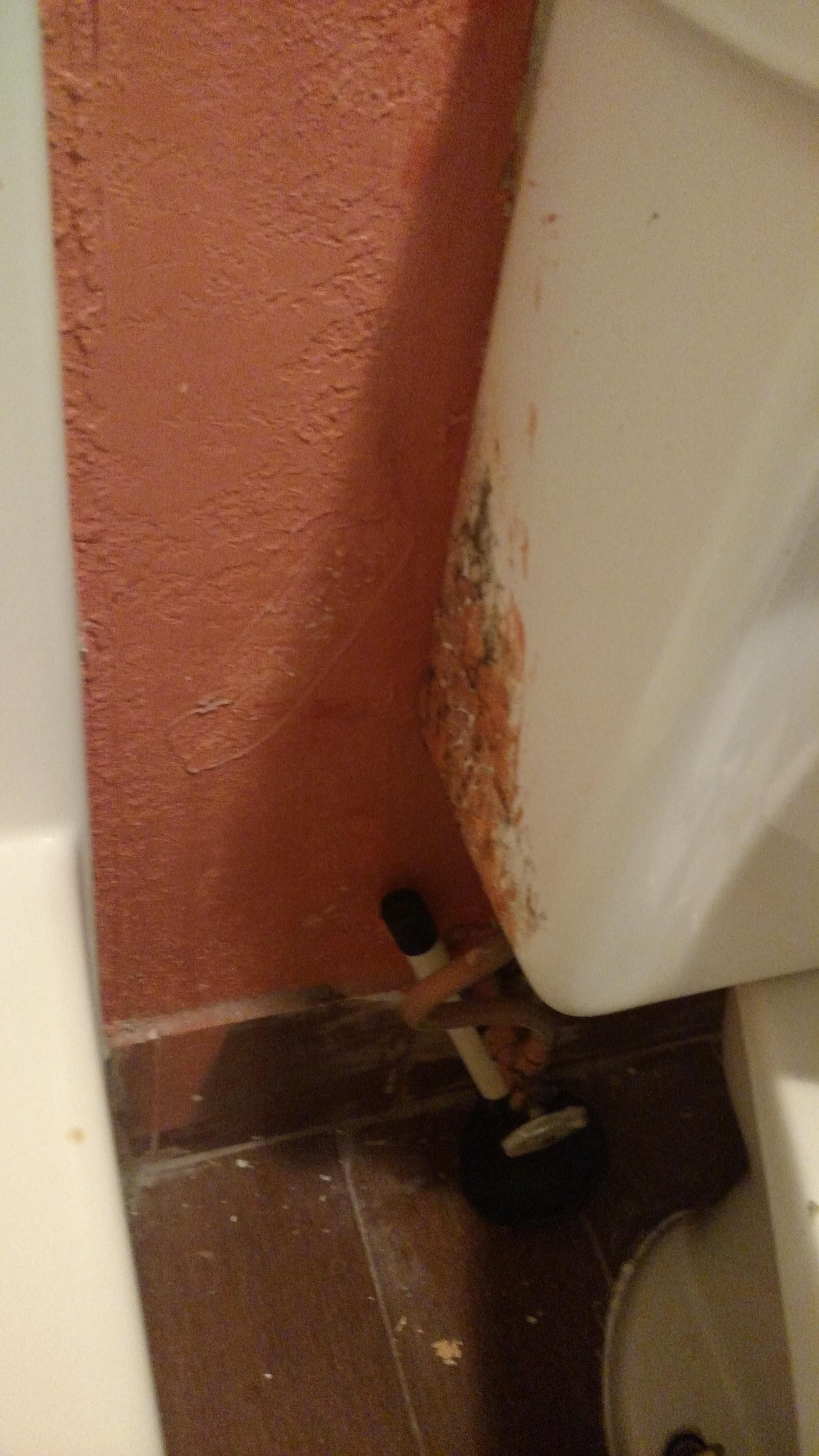 Behind TV stand
