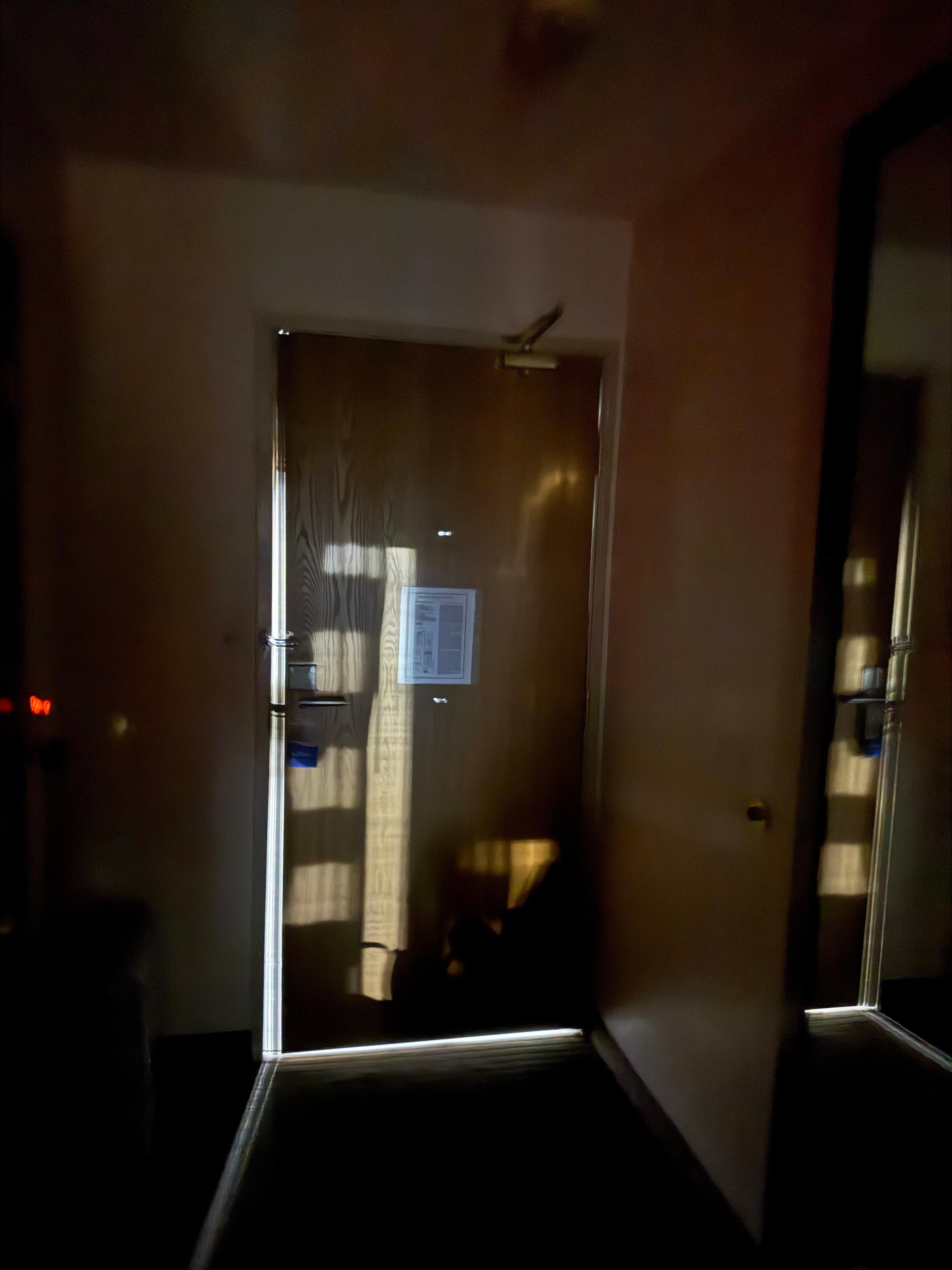 Door is closed but there are gaps all around so you can hear everything outside the room.