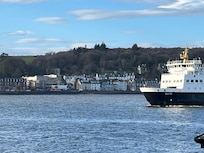 The flat is in the distance just ahead of the bite of the ship.