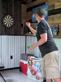 Hubby playing darts
