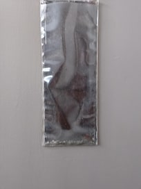 Random pouch on back of door filled with debris.