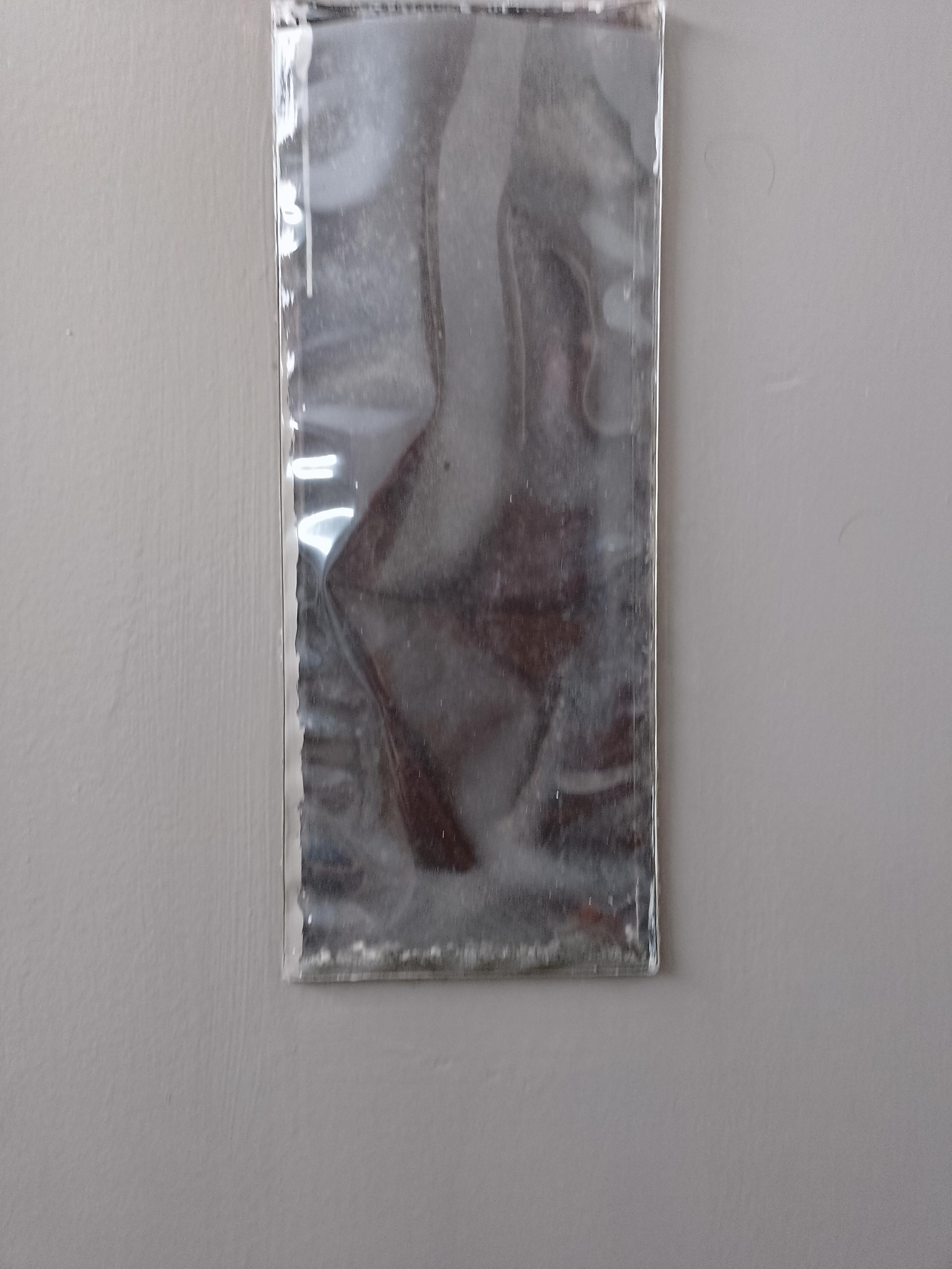 Random pouch on back of door filled with debris.