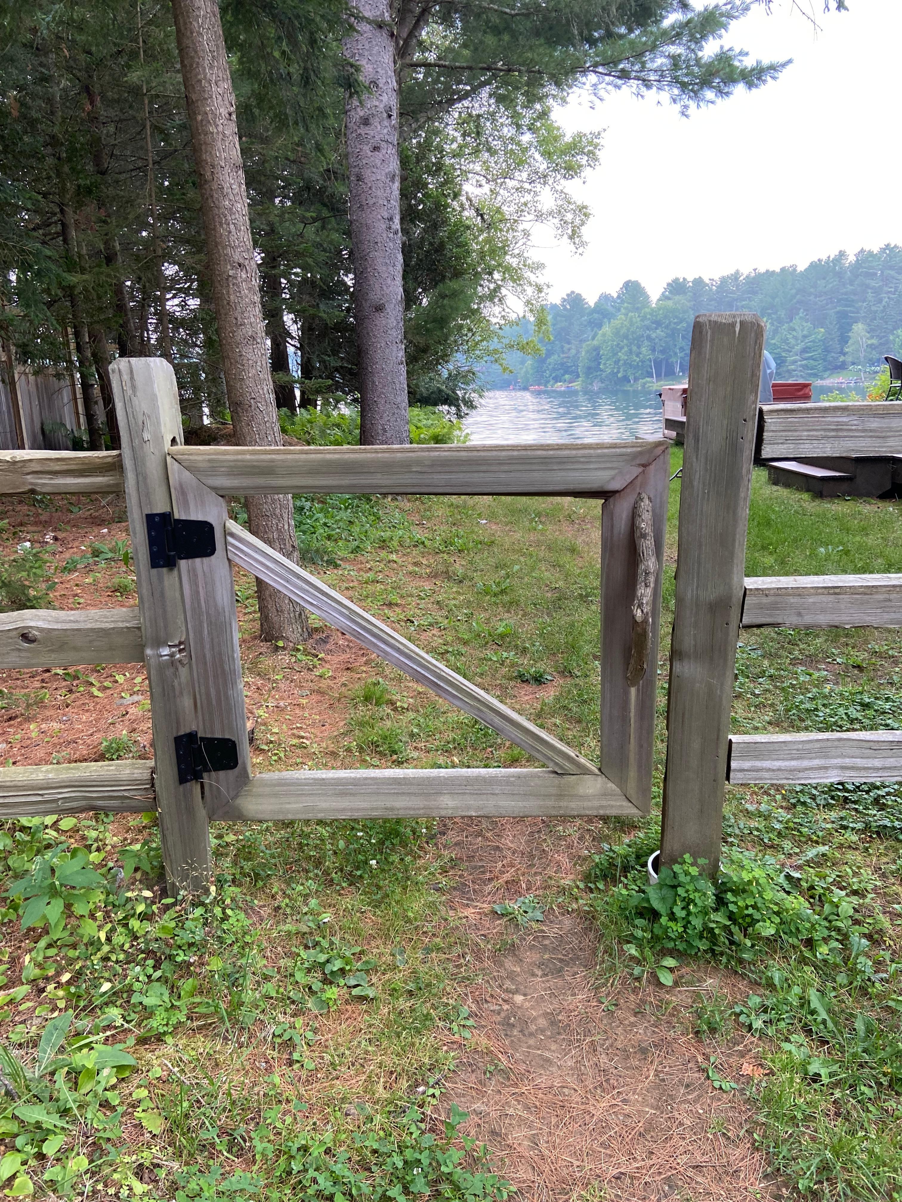 Gateway to the lake ! Loved the split wood fencing look . 