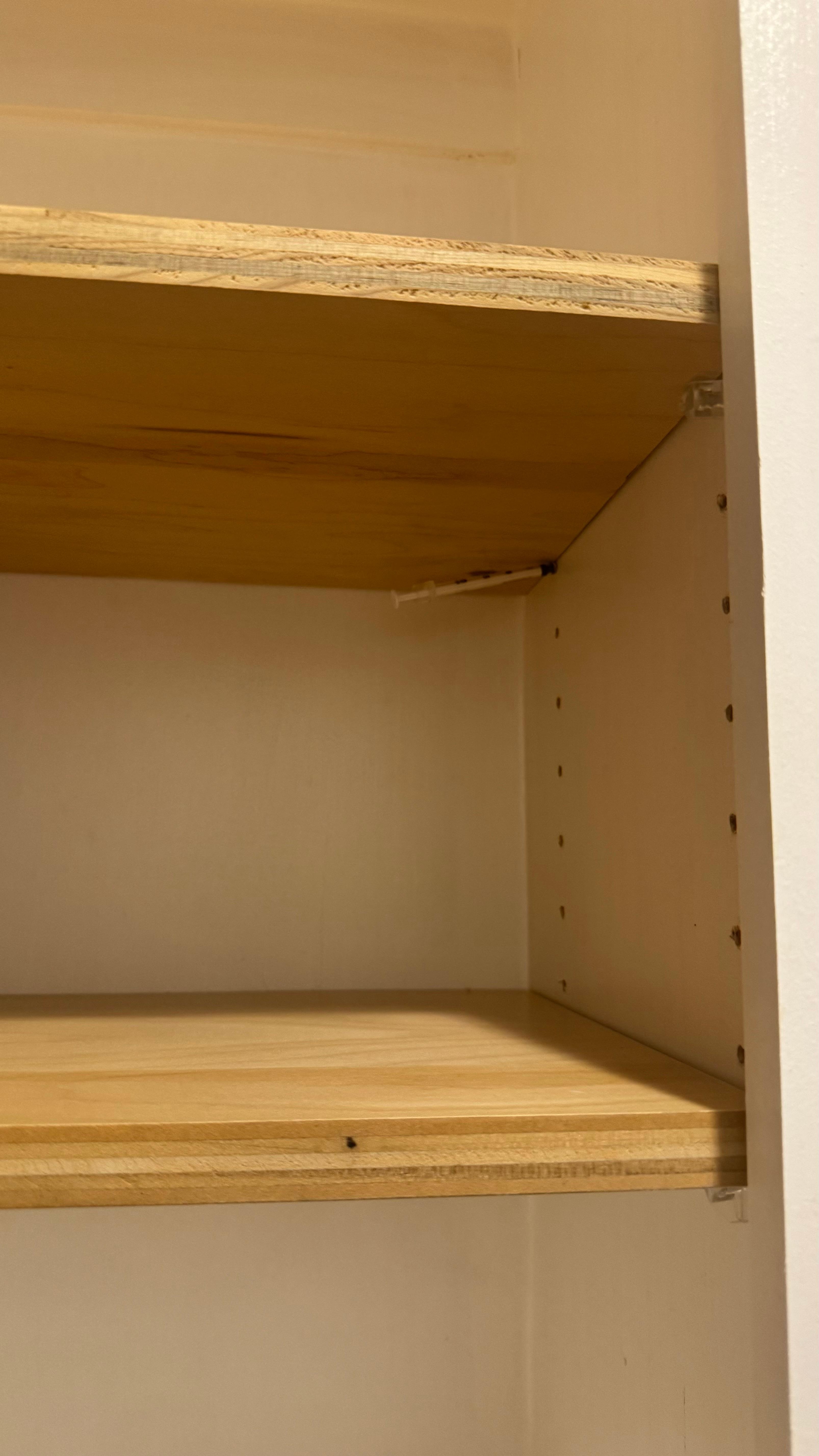 Needle in top cabinet to the left of the oven.