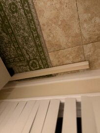 Additional valance pieces on the ground in the living room