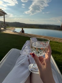 Having a drink by the pool at the e end of the day