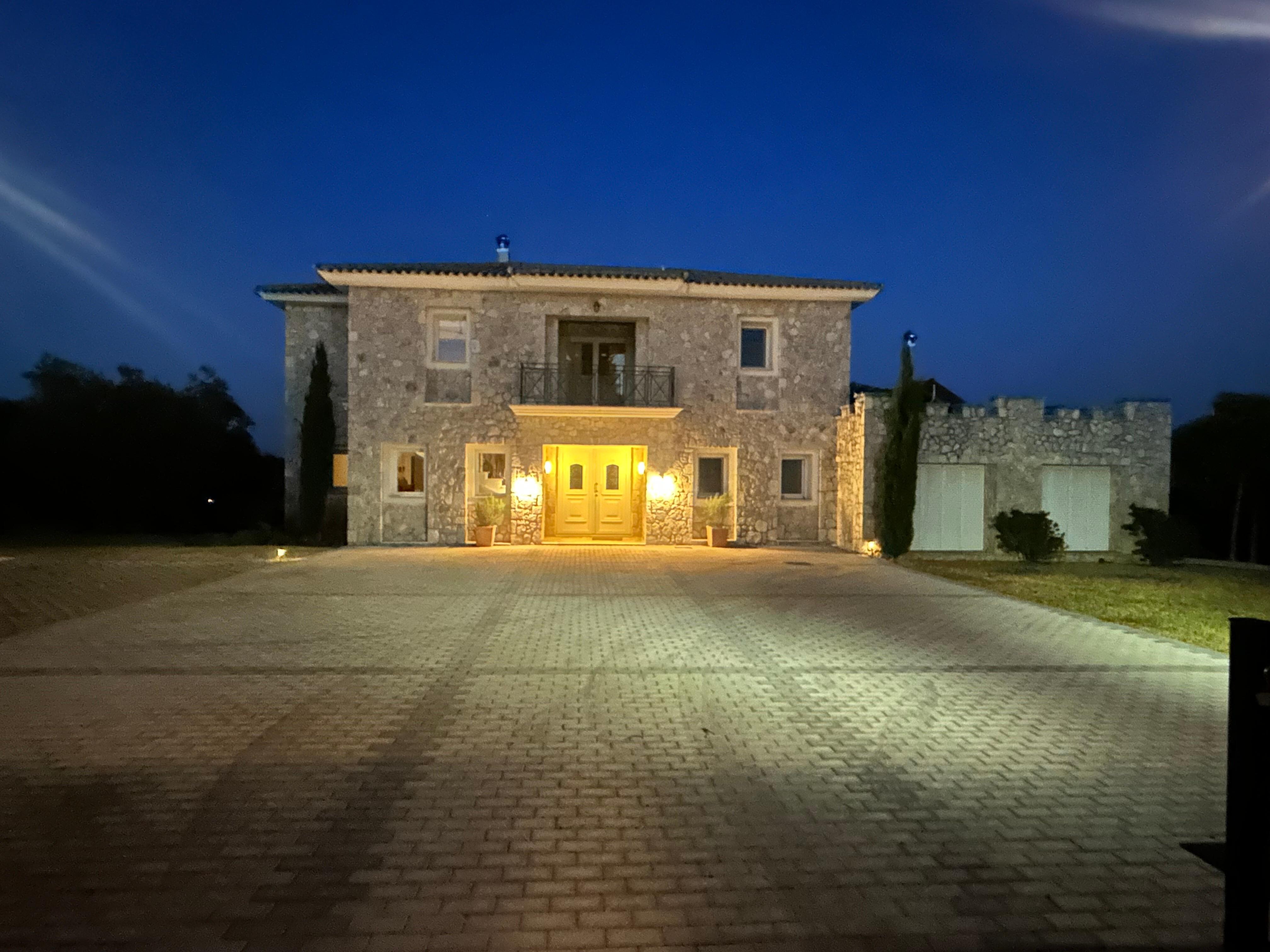 The impressive Villa Balatsinos lit up in the evening.