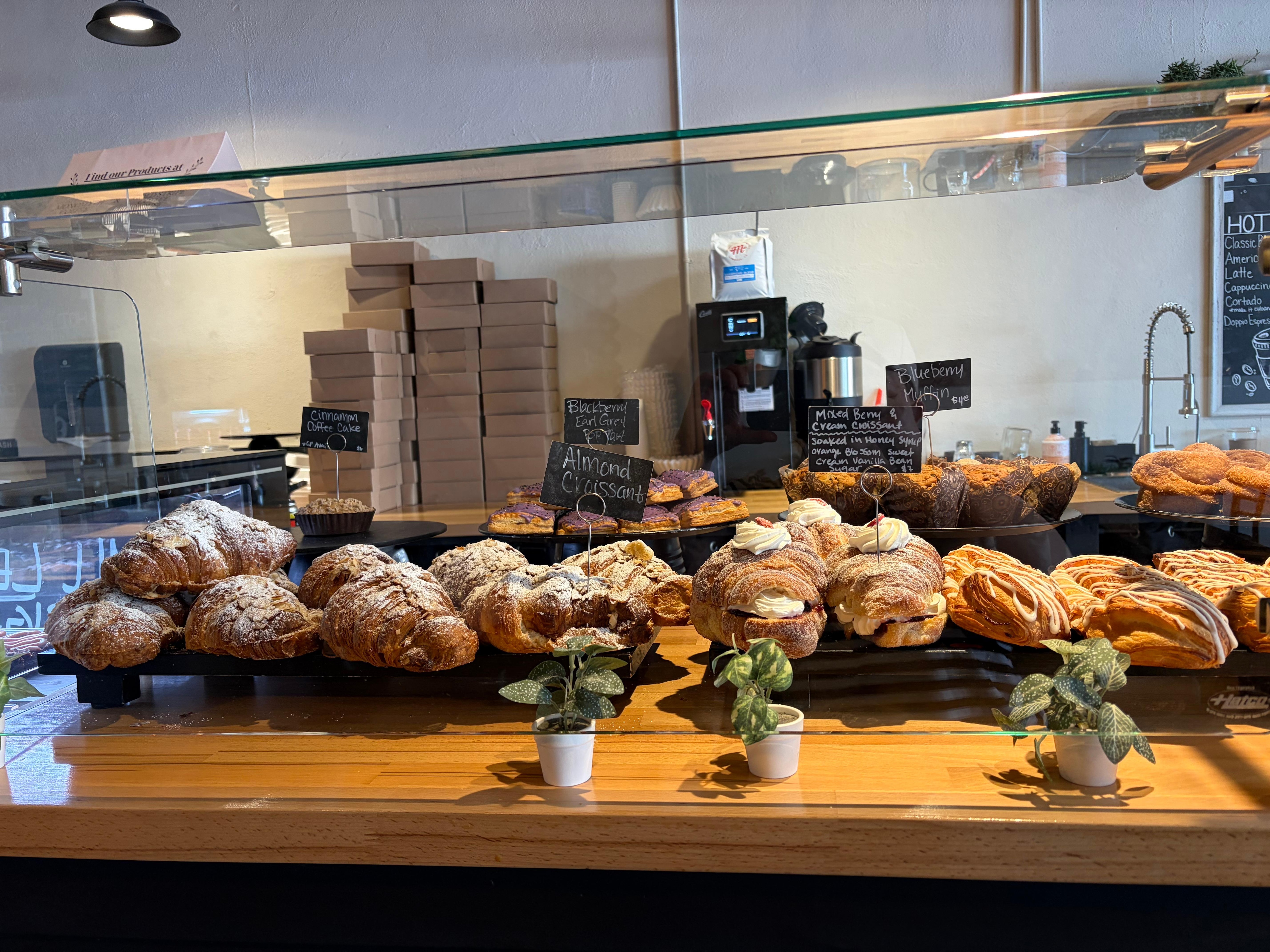 Glorious assortment of croissants, pop tarts, cinnamon coffee cake, and blueberry muffins at Brûlée Bakery