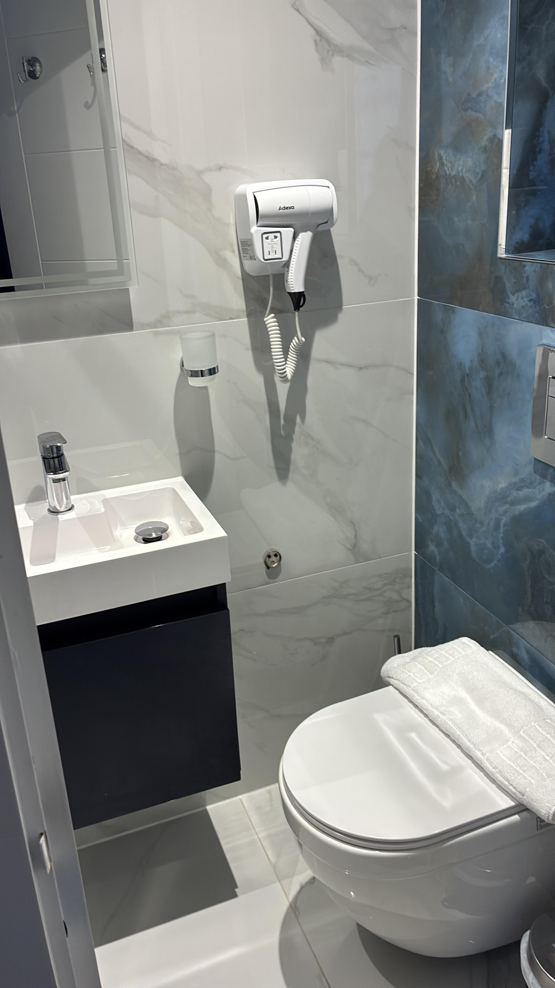 Sink, makeup mirror and toilet