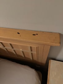 Cigarette burns on headboard