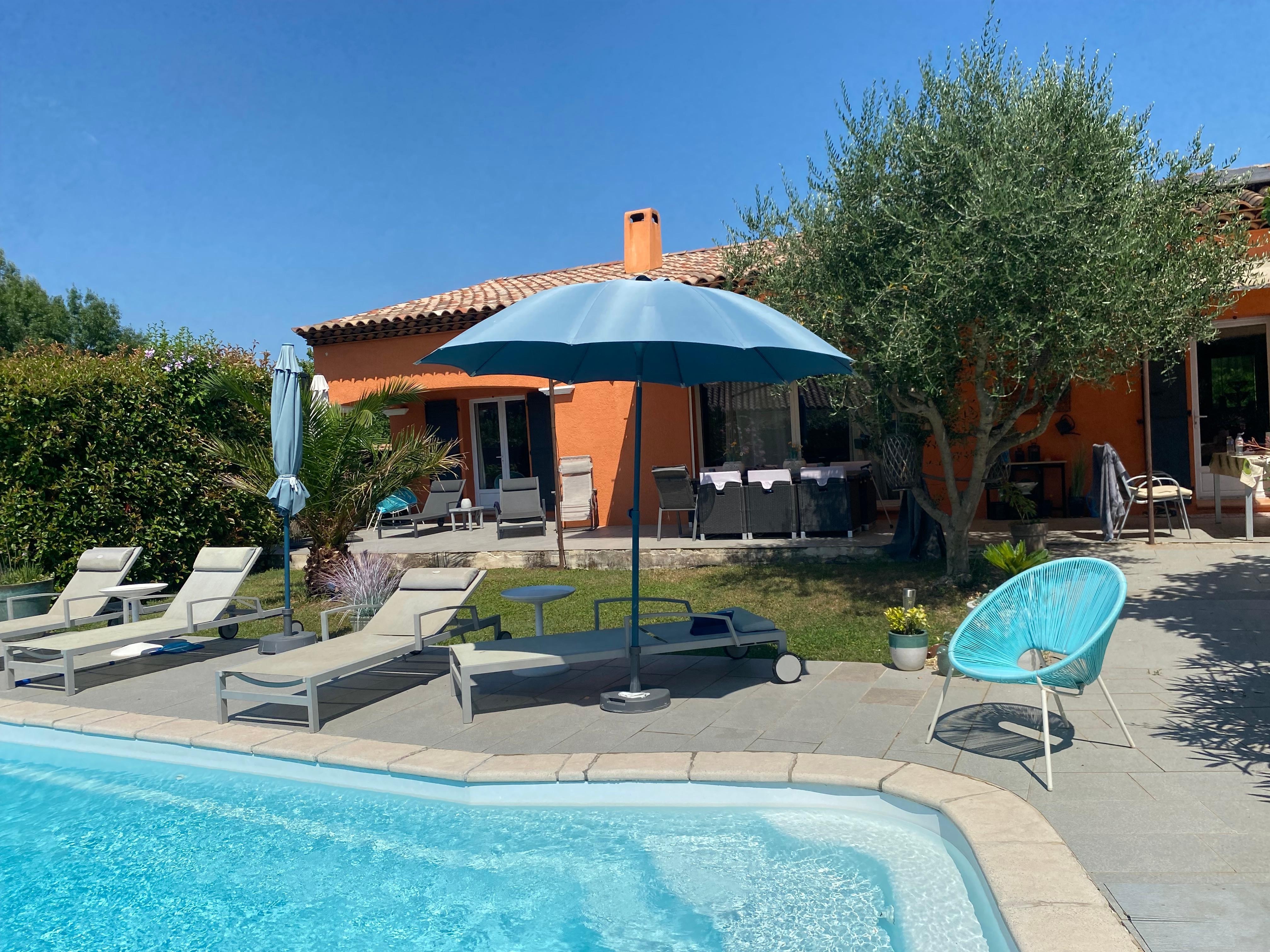 Pool with house and part of the shady terrace in the background