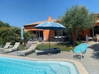 Pool with house and part of the shady terrace in the background