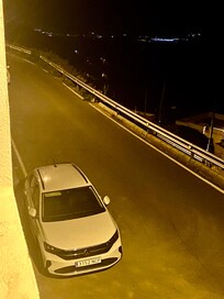 On street parking and seeing the lights near the shoreline many kilometres away.