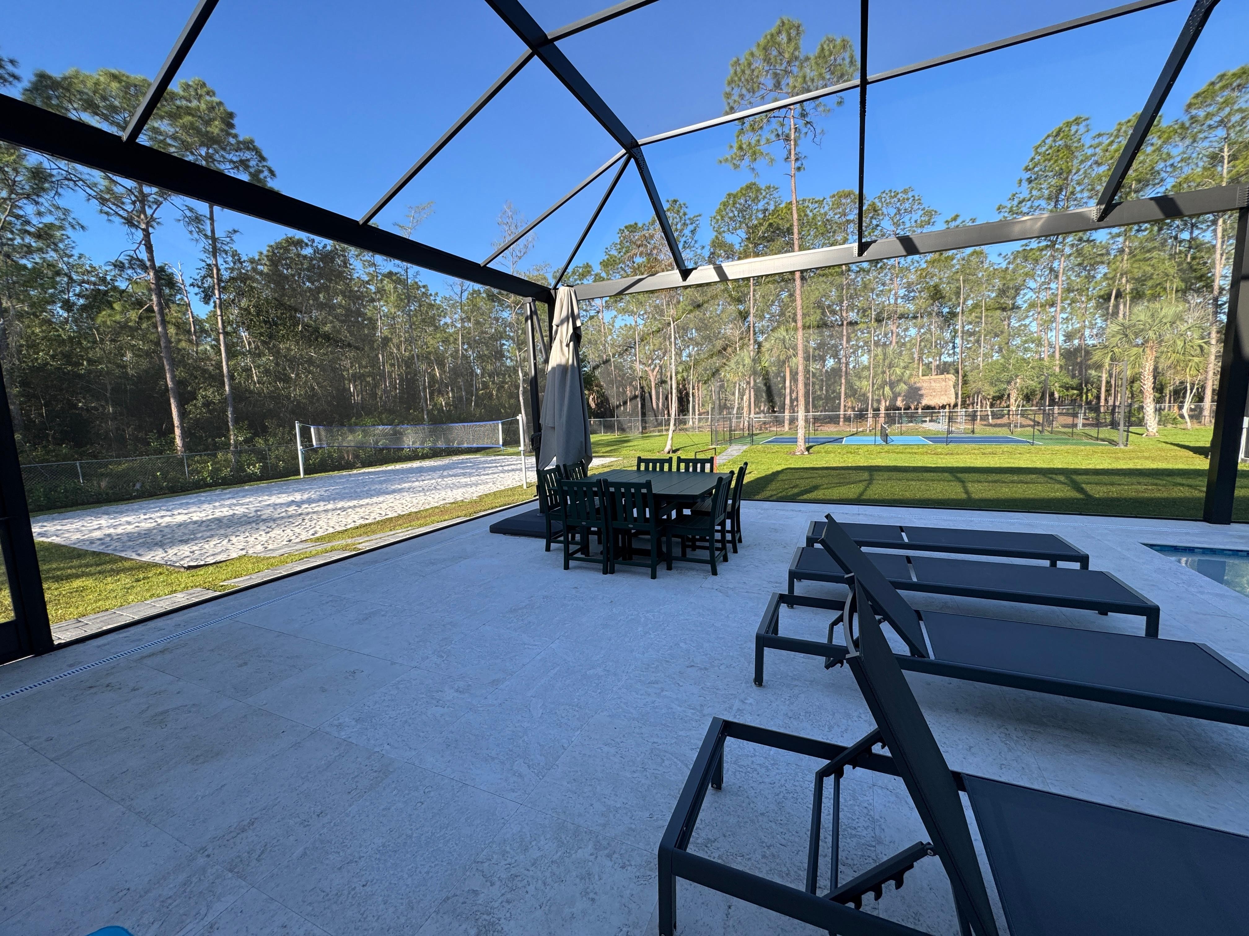 Umbrella and dining table next to pool