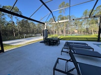Umbrella and dining table next to pool