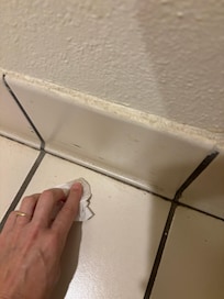 Dirt along edges in bathroom.