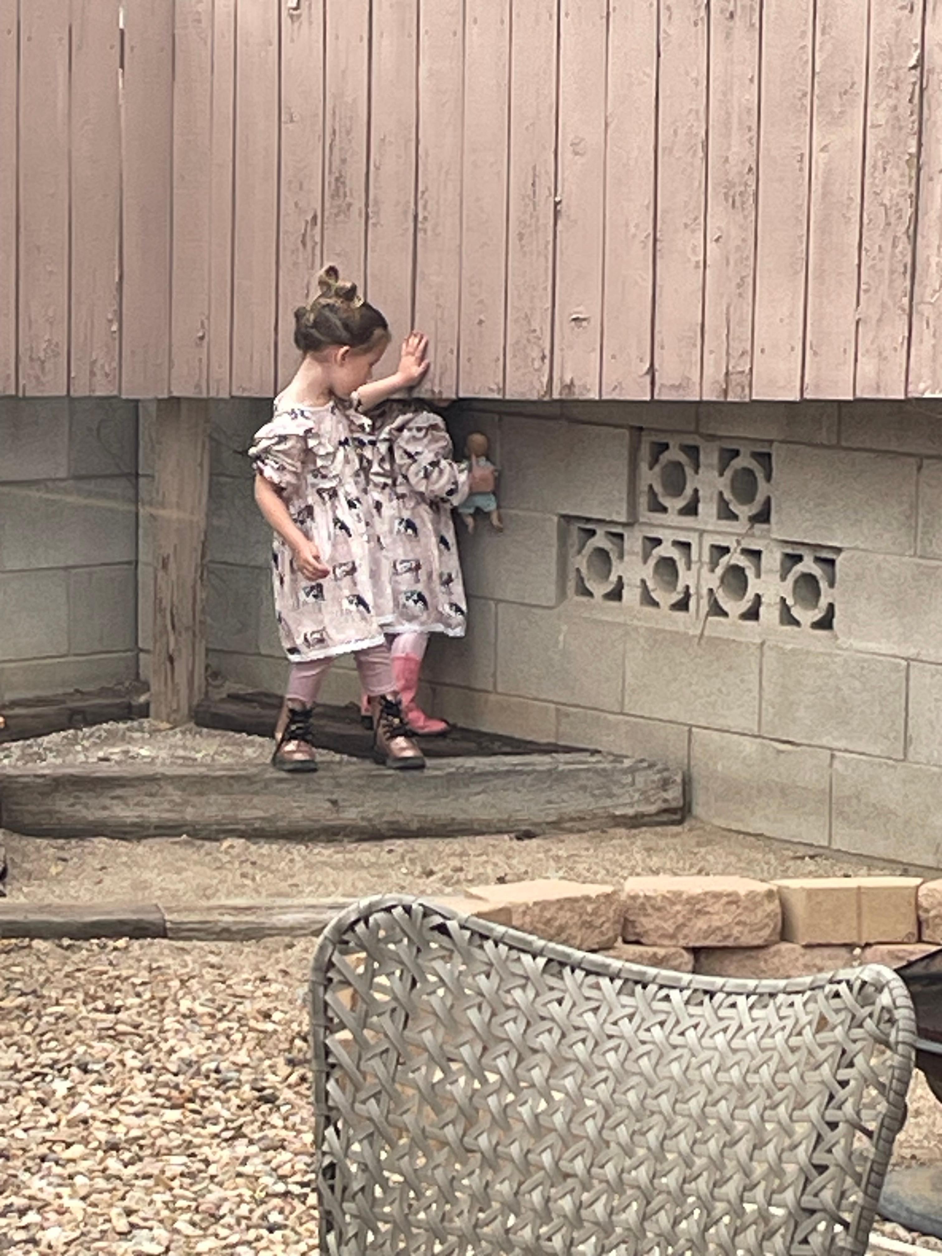 The grandbabies ready to leave for the shower playing in the back yard!