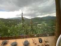 Absolutely beautiful view from the lodge, where you can see the mountains as well as more outdoor seating.