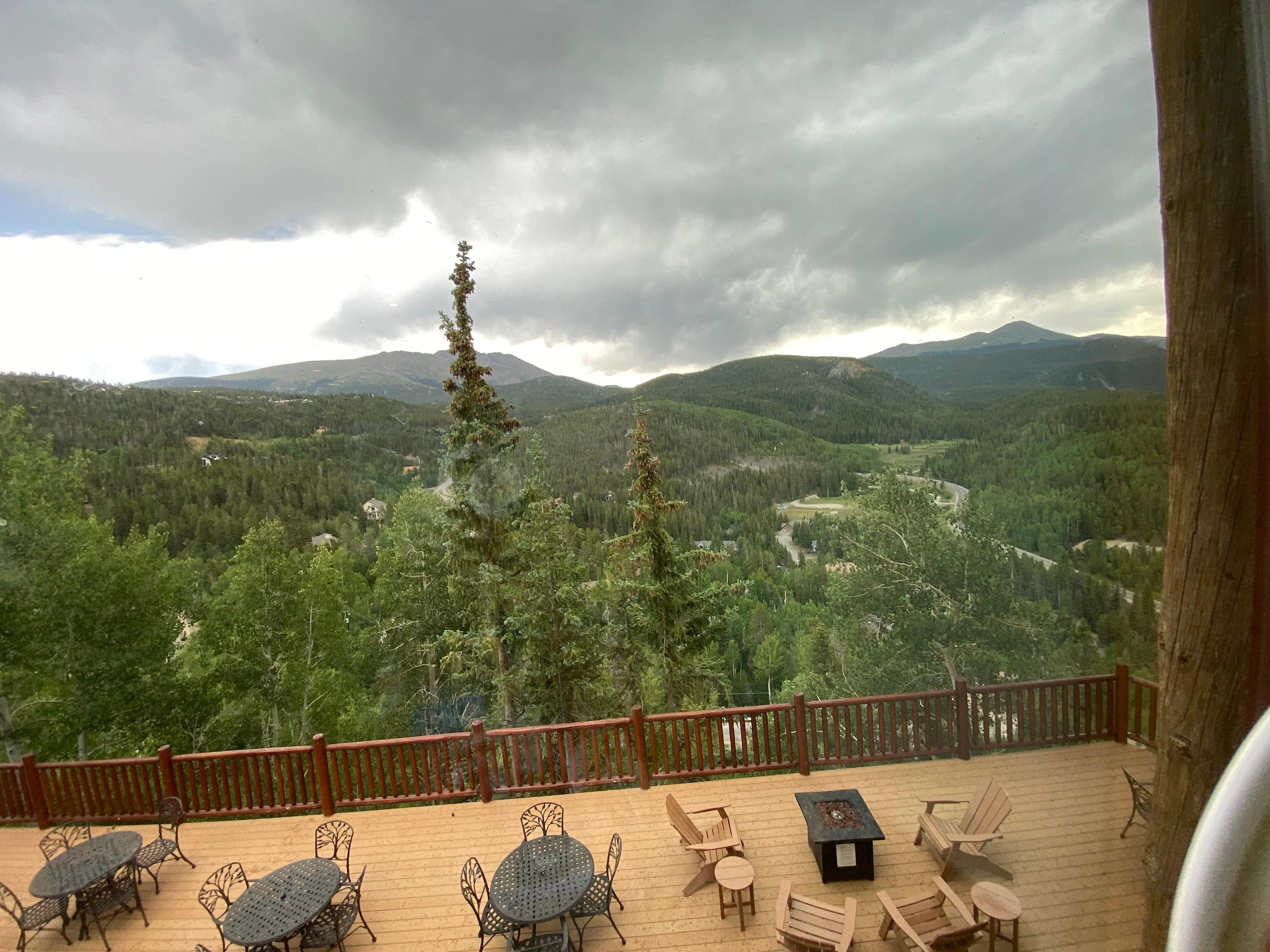 Absolutely beautiful view from the lodge, where you can see the mountains as well as more outdoor seating.