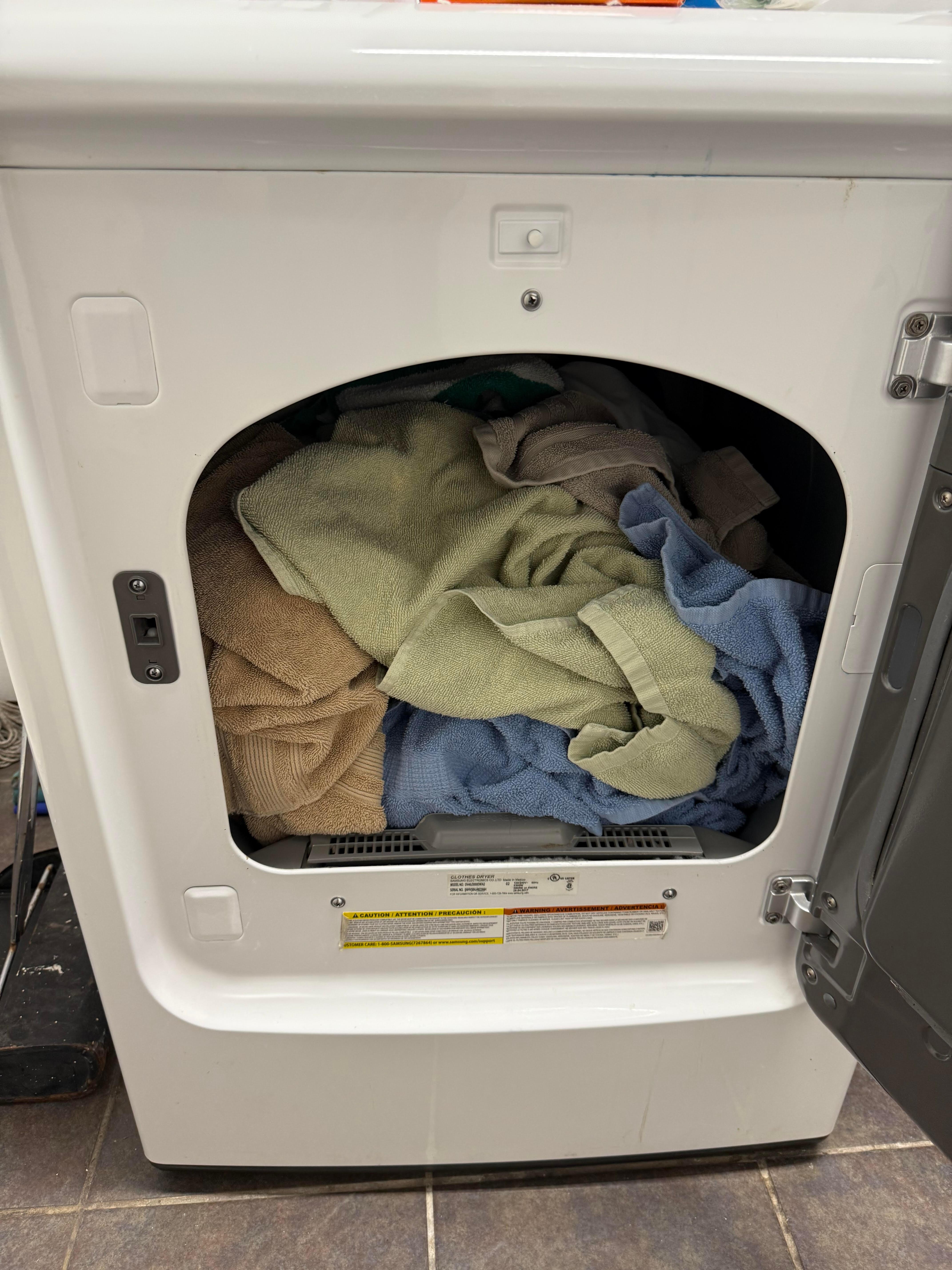 Sheets and towels in dryer.