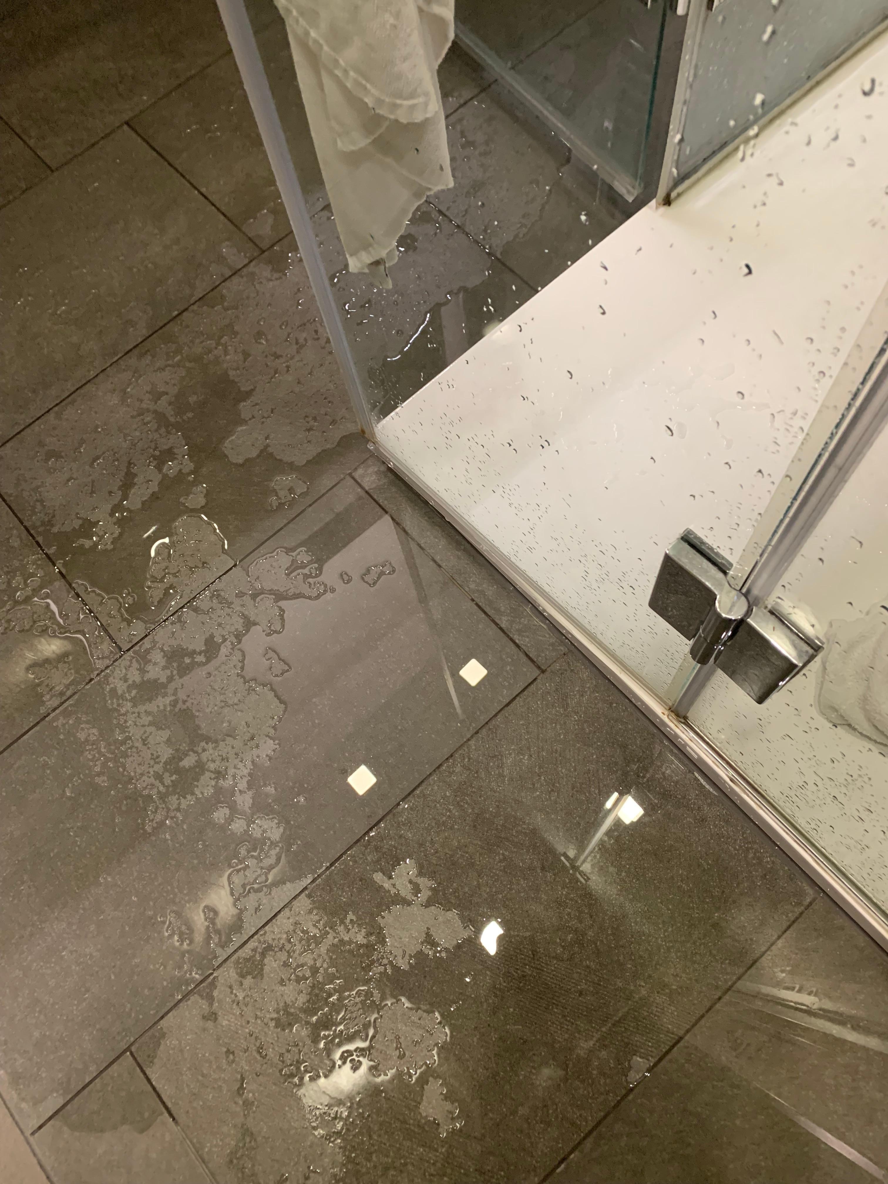 Puddles of water on the floor after a shower 