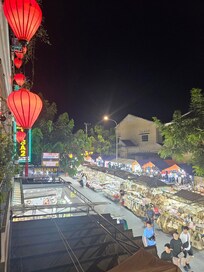 View of night market from hotel balcony