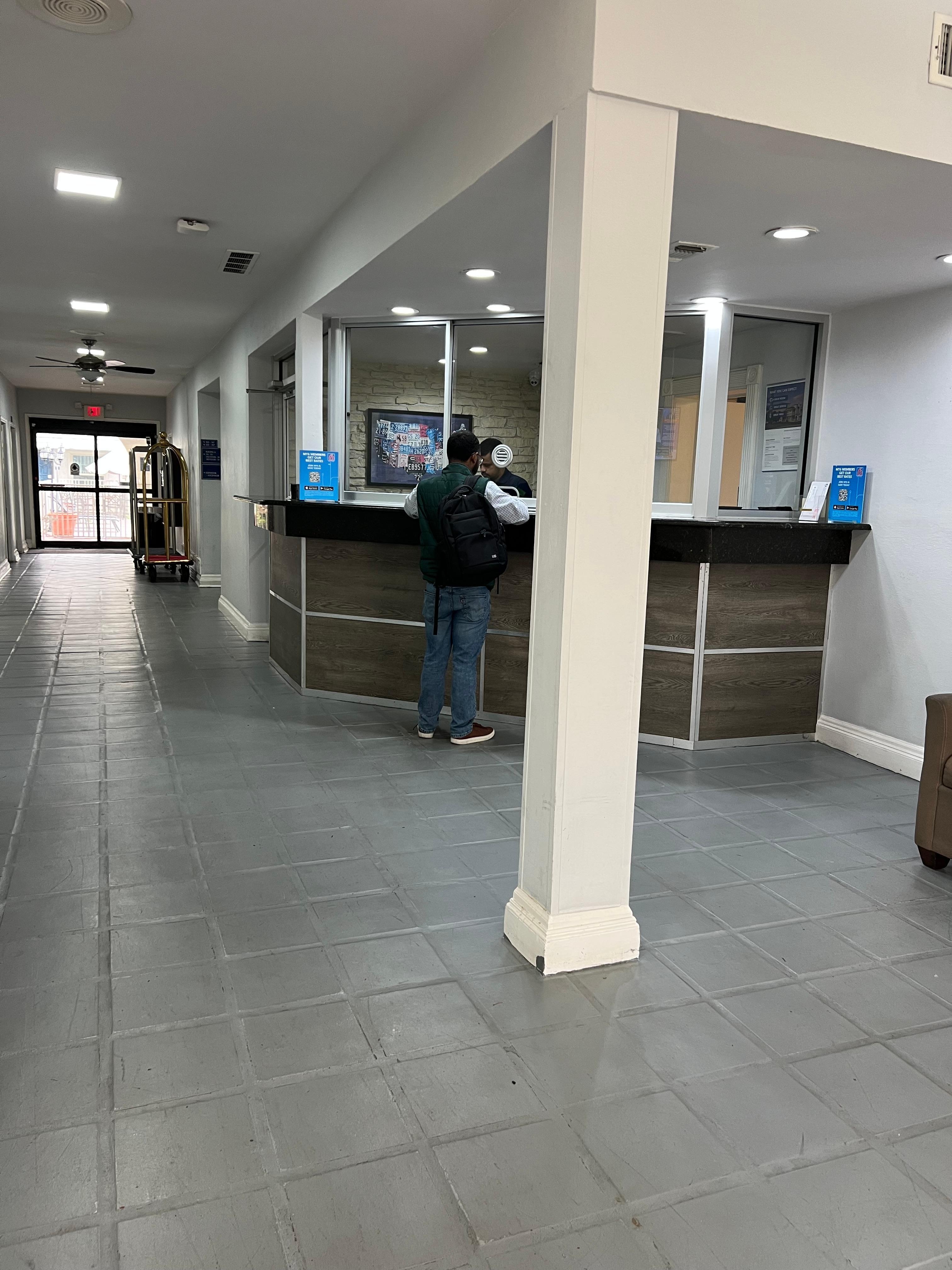 Depressing gray lobby with bullet proof glass 