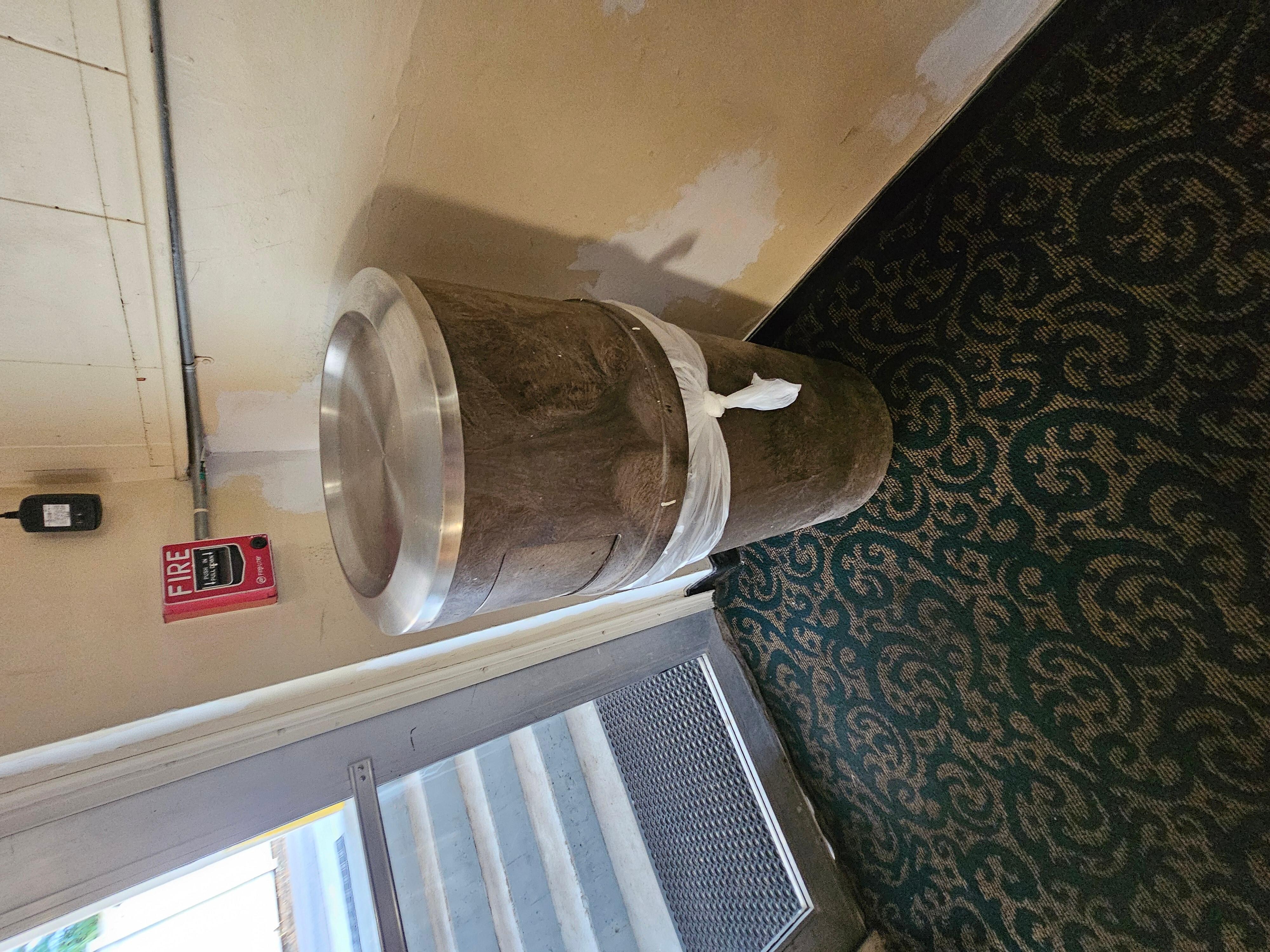 Trash can at the end of the hallway was filthy.