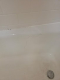 Long hair stuck to the side of the shower