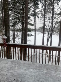 Looking out the slider window toward a frozen snow covered Lost Lake