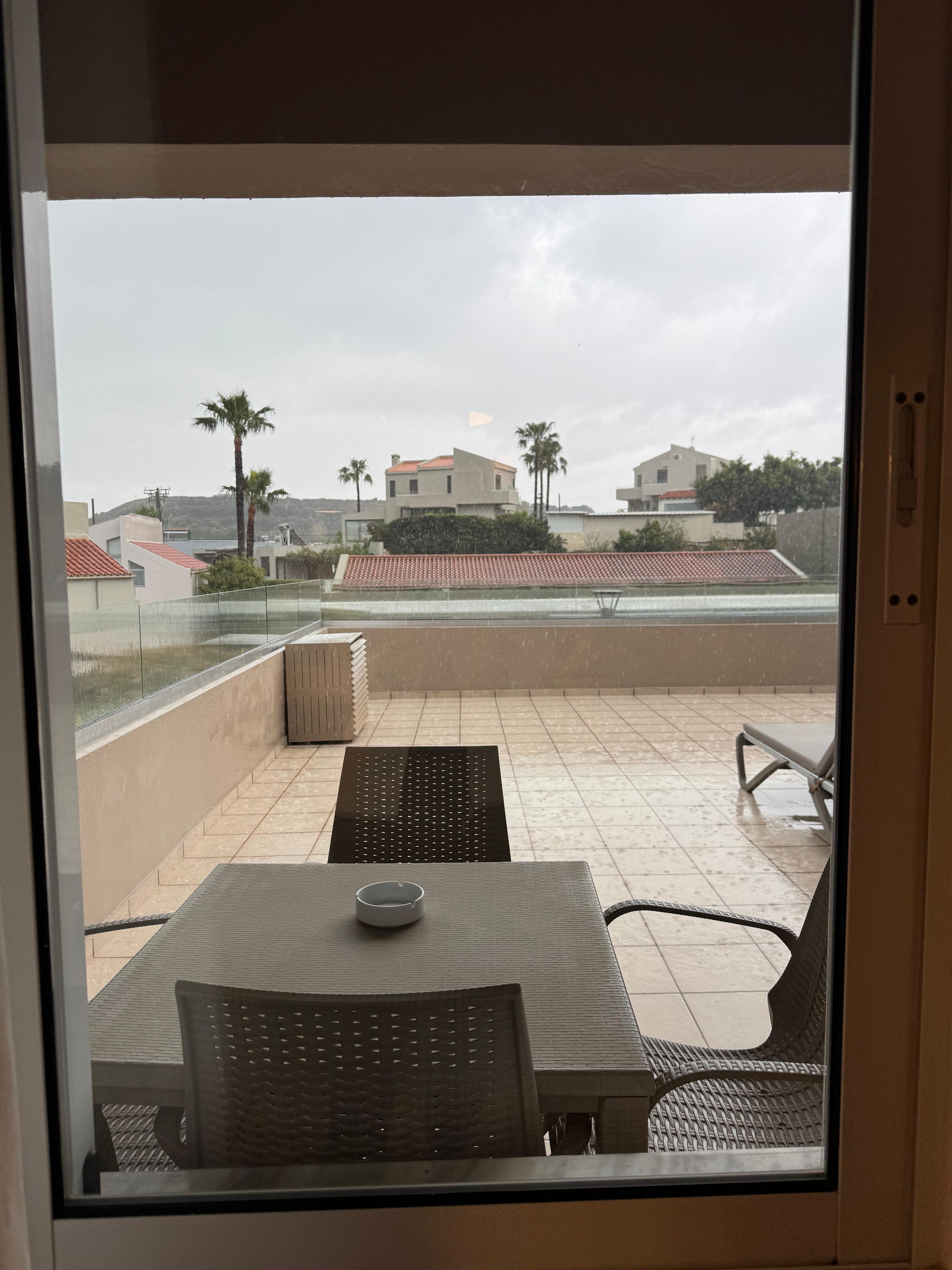 Junior suite 45 (end unit, second floor) balcony and outdoor dining table viewed through the hige kitchen windows