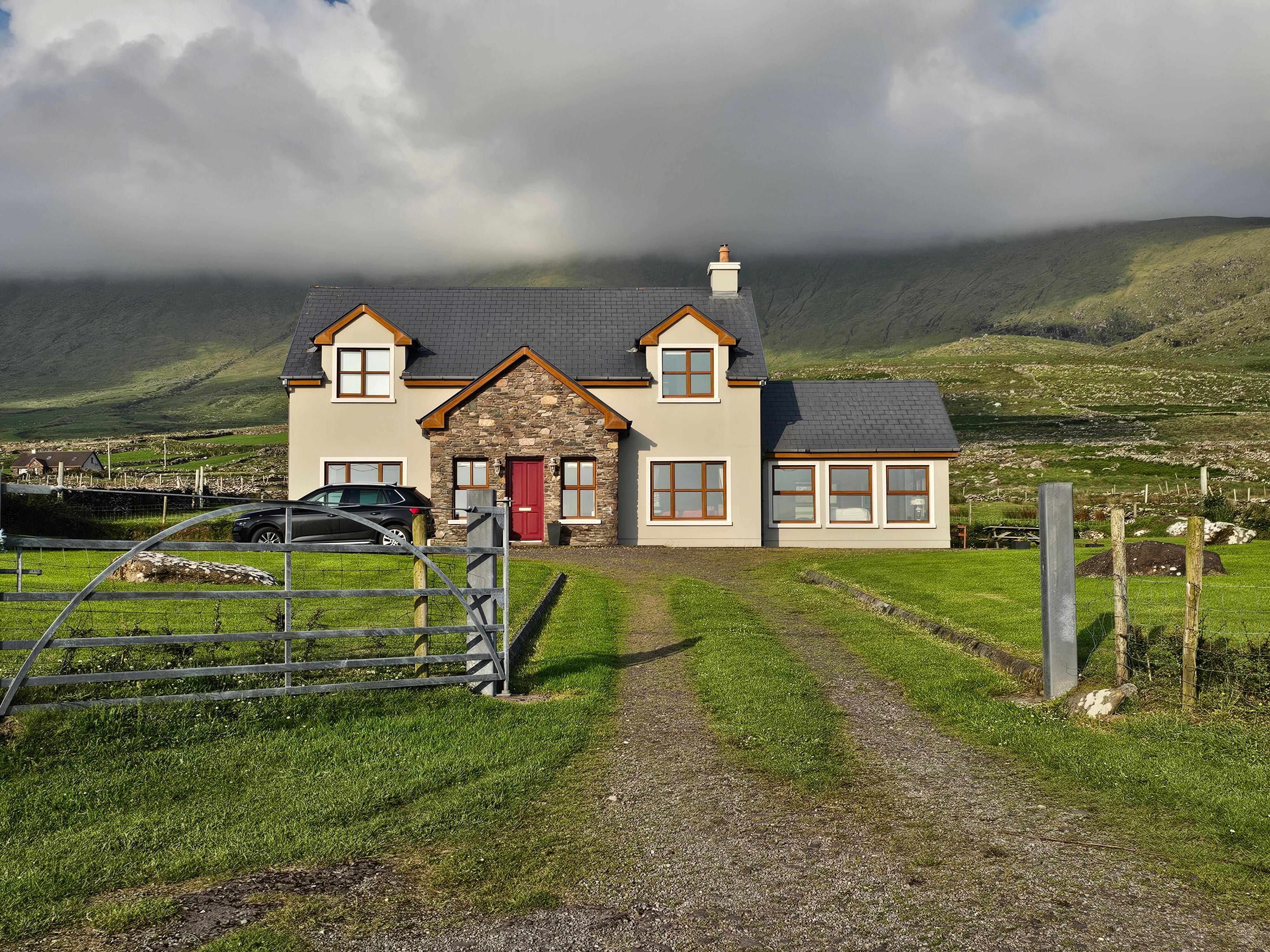 Front of the house with Mount Brandon behind it in the clouds.  Beautiful!!