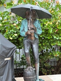 Sheltering the frog statue from the rain