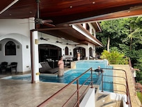 View from separate master towards main house...spent 99% of our time out there watching the rains, in pool etc!