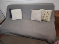 Soiled couch cover, sloppy and distasteful.