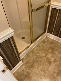 Old shower door with broken track and dirty interior