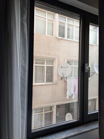 If you're familiar with Şirinevler, you know it's not a tourist destination—and neither is this hotel. This is the view from the room, and yes, that's laundry and satellite dishes on a worn facade.