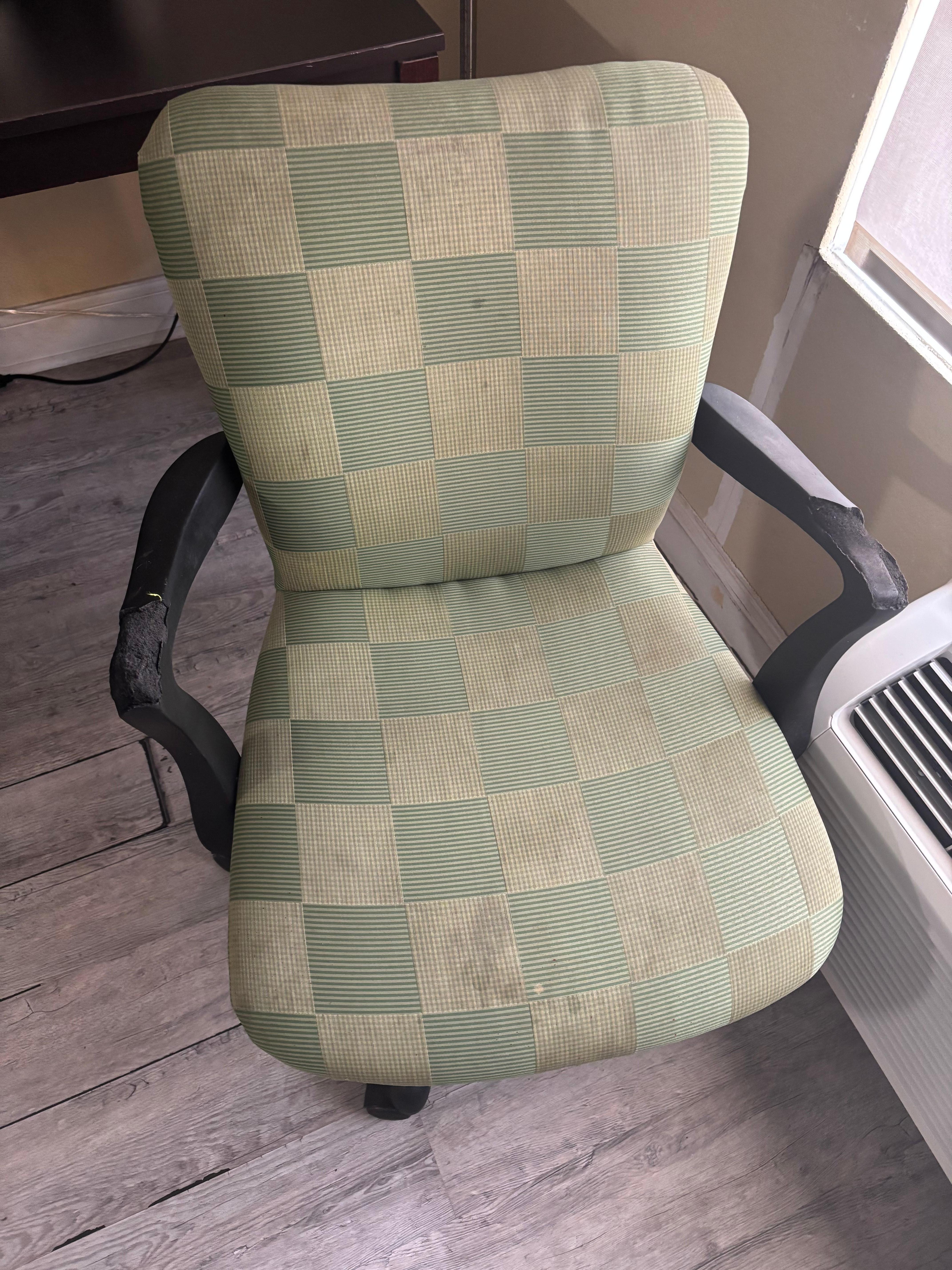 Desk chair with arms torn up and stained seat
