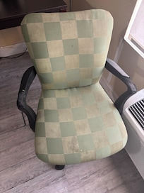 Desk chair with arms torn up and stained seat