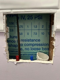 Hole in bathroom wall that could be reason for the mouse droppings we found