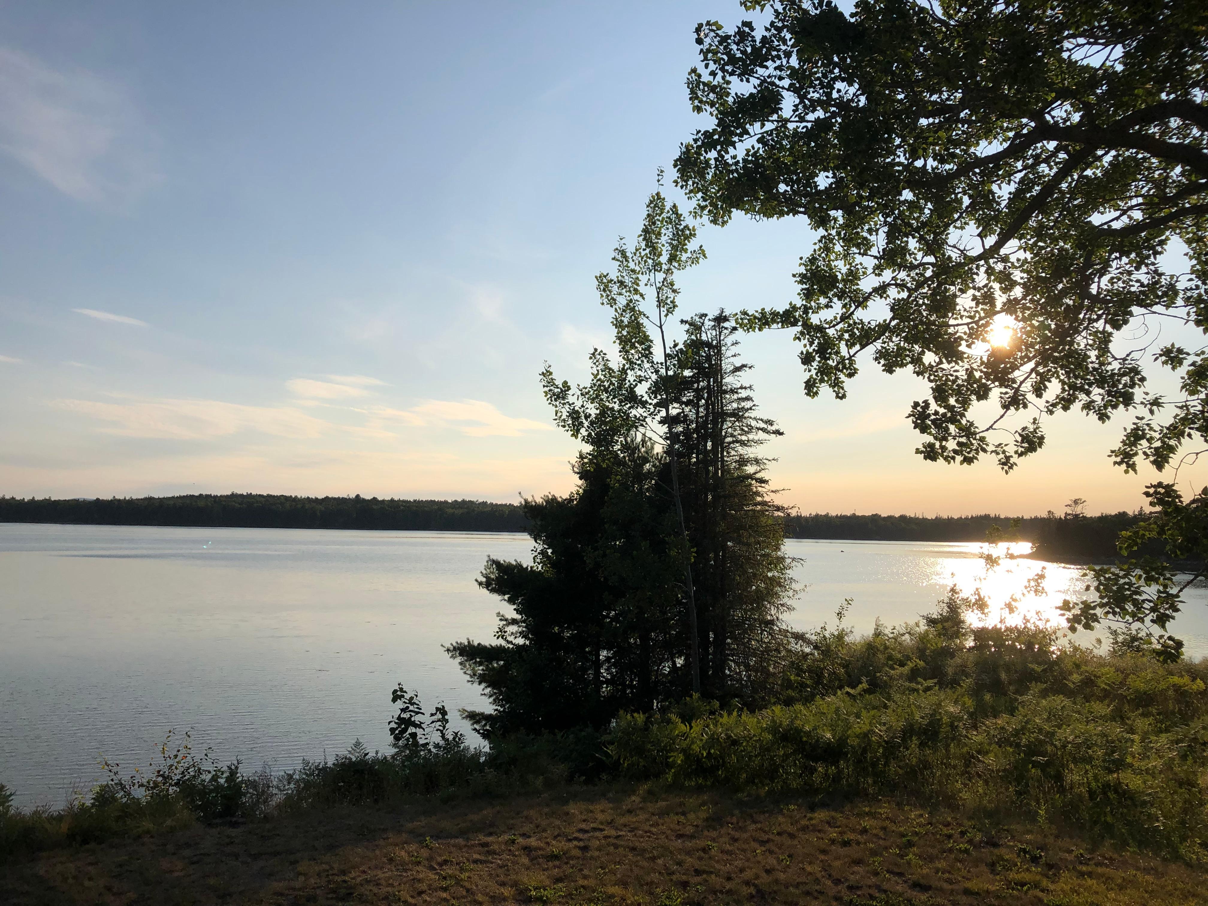 Sun setting in front of the cottage.