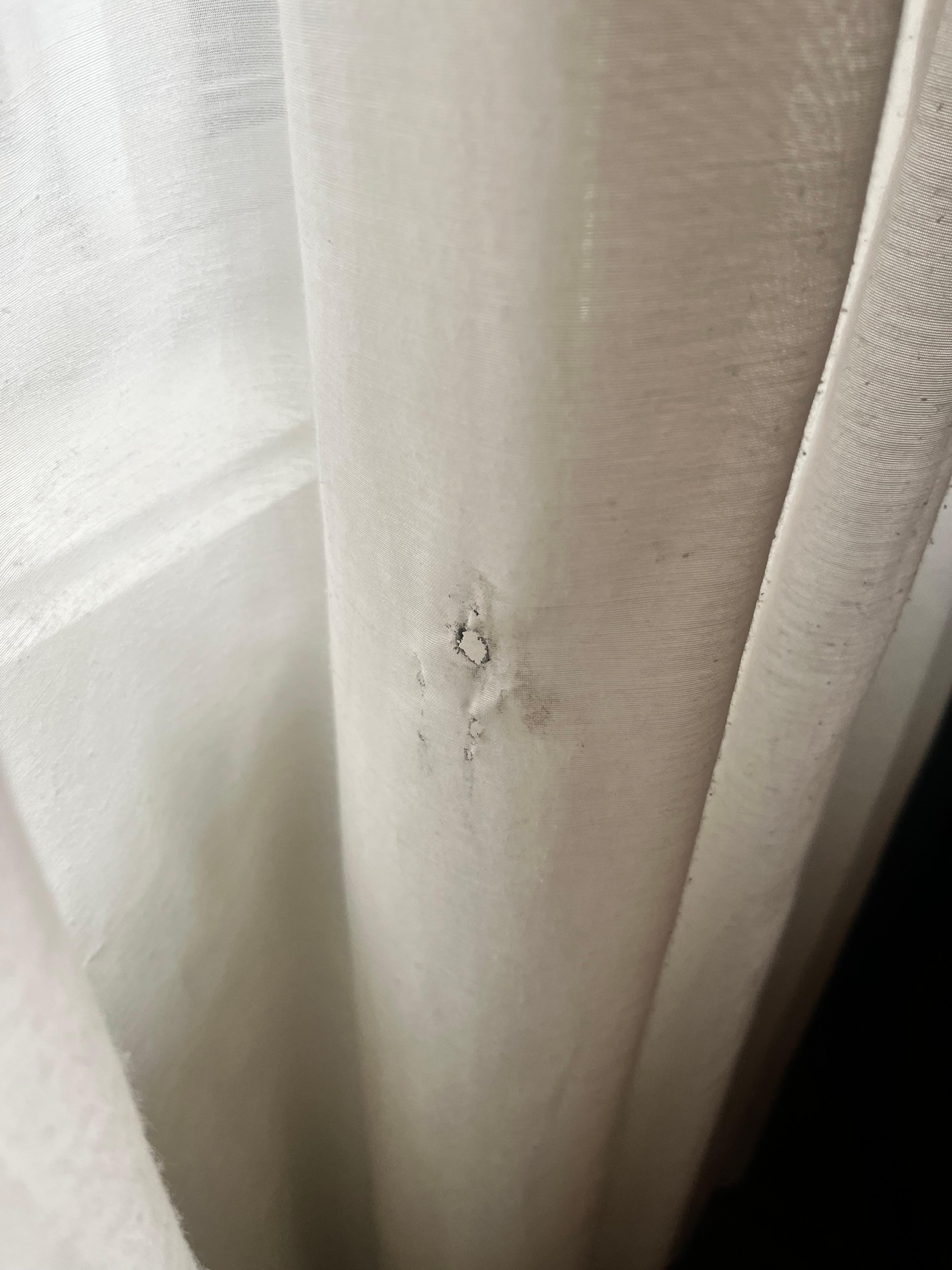 Cigarette burn in the curtains