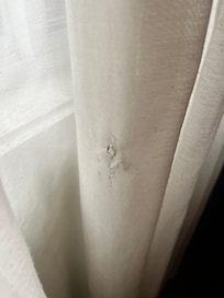 Cigarette burn in the curtains