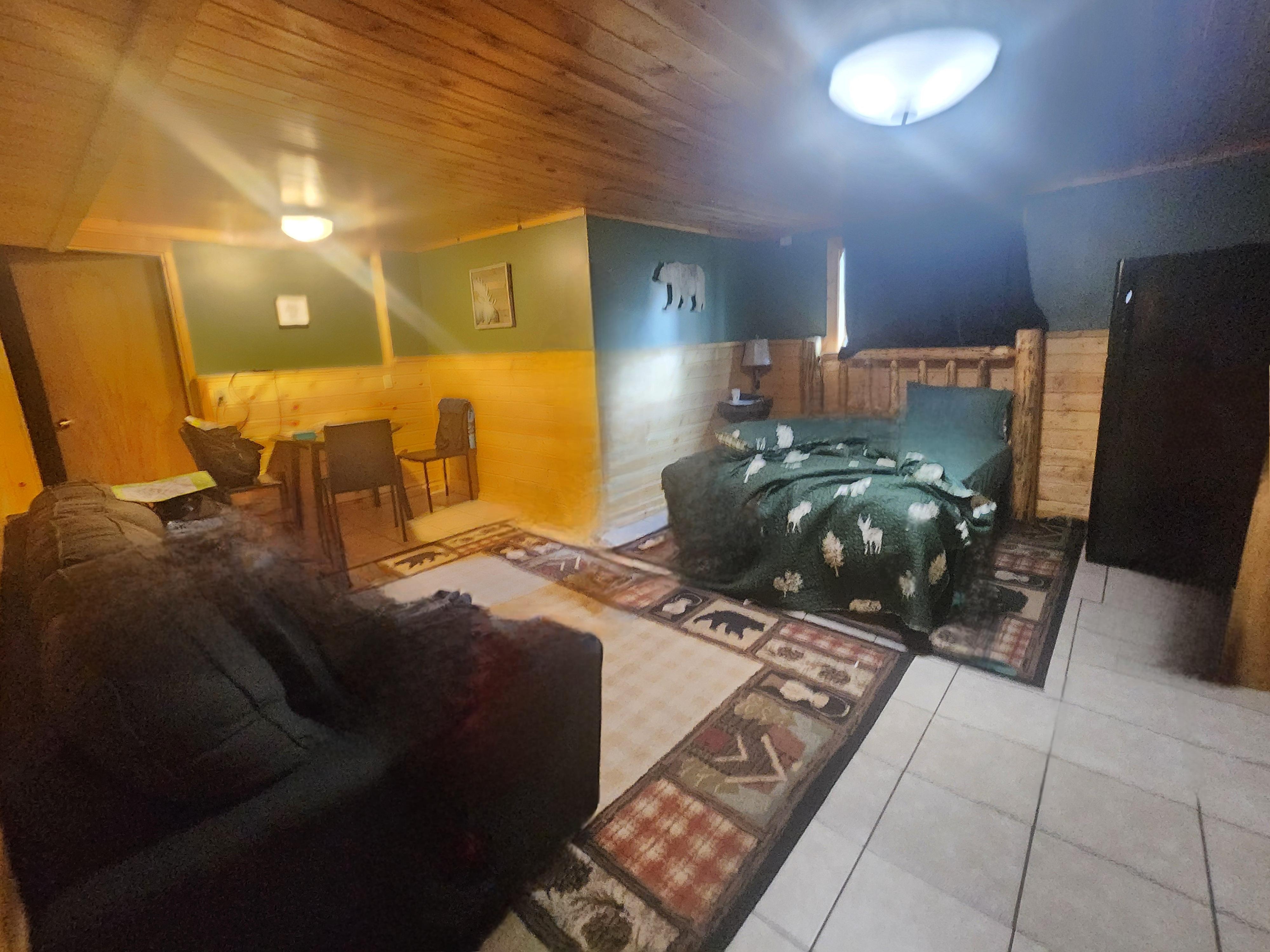 Main bed/fridge area from bathroom/bunkbed side. Picture out that window above bed in this review also.