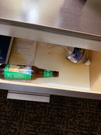 Spilled beer and garbage in nightstand.