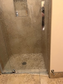 Shower door doesn’t close, leaks out, pools on bathroom floor