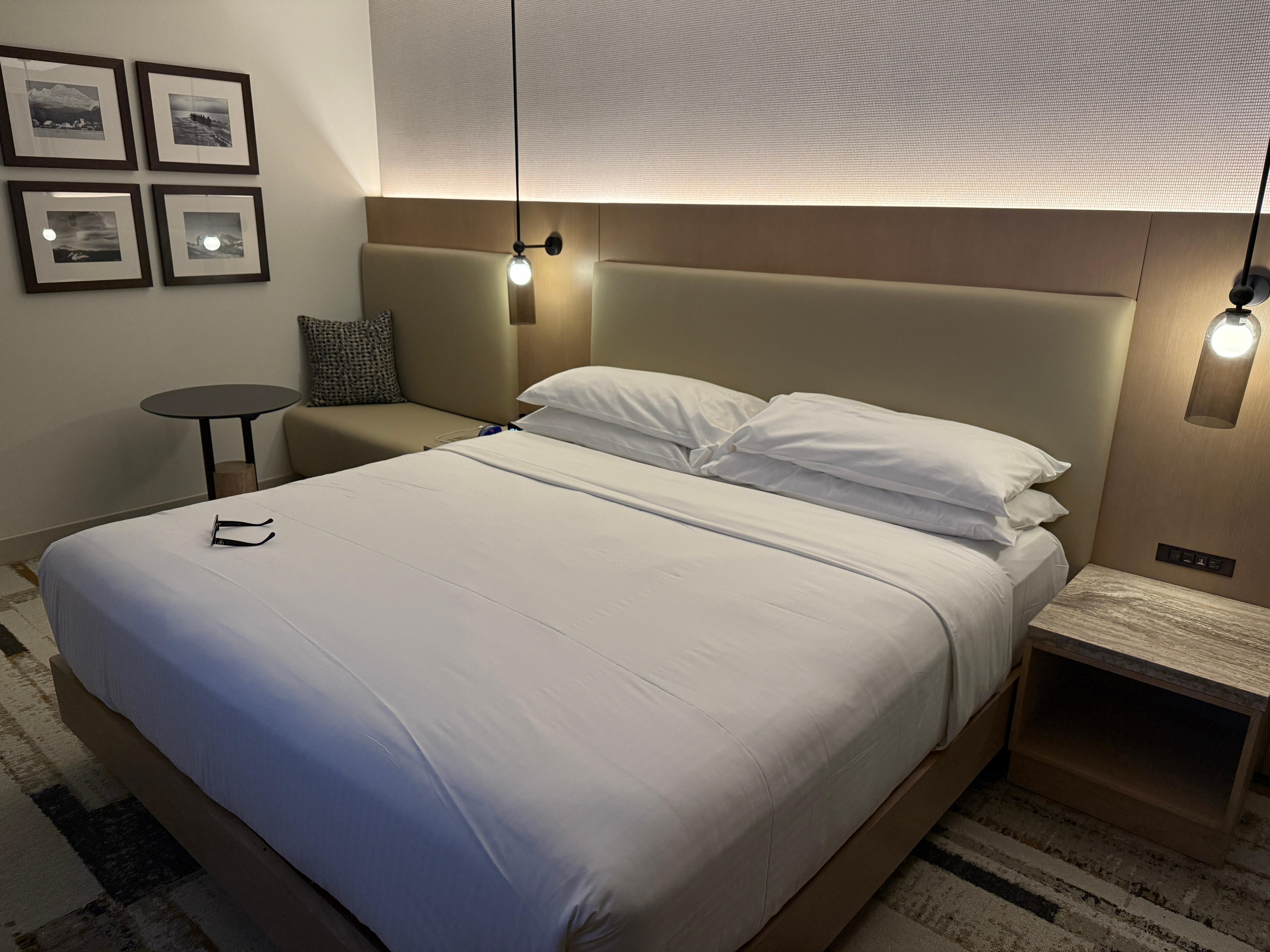 Room with king bed and small dining table 