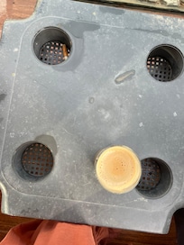 Dirty old plastic sunbed table with old cigarette Stubbs left in the drinks holder !