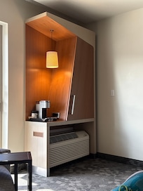 Pleasant coffee station with small fridge and ice bucket behind cabinet. No microwave otcsafe
